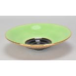 PETER COLLIS; a porcelain dish partially covered in lime green and mottled gold glaze, painted