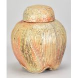 RUTHANNE TUDBALL (born 1948); a stoneware ginger jar covered in soda glaze with swirling incised