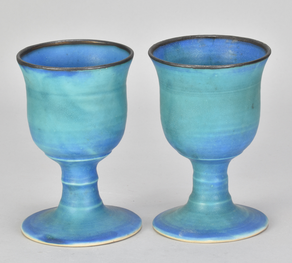ABDO NAGI (1941-2001); a pair of stoneware goblets covered in copper barium glaze with bronze