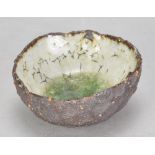 AKIKO HIRAI (born 1970); a miniature stoneware pond bowl with lime green glaze pooling to the