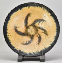 ABDO NAGI (1941-2001); a stoneware charger/wall hanging covered in mottled yellow and blue glaze