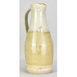 MARK GRIFFITHS (born 1956); a tall stoneware pitcher covered in pale green ash glaze with nuka top