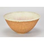 SOTIS FILIPPIDES (born 1963); a stoneware bowl with carved exterior and cream glaze with pinkish