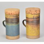 ROBIN WELCH (1936-2019); a pair of stoneware mugs with cork covers, impressed marks, height 15.