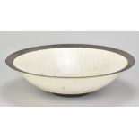 RUDIE DELANGHE (born 1955); a large raku bowl partially covered in white crackle glaze, incised