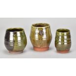 JOSHUA WILLIAMS; a group of three slipware cups, impressed oak leaf marks, tallest 10cm (3). (D)