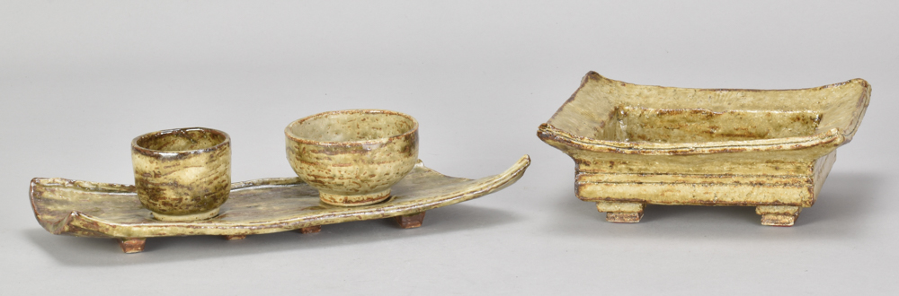 ALAN BIRCHALL (born 1945); a stoneware olive dish set comprising two bowls and a tray covered in
