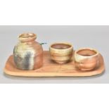 MASANOBU IZUMIHARA; a wood fired stoneware sake set comprising a jug, pair of cups and rectangular