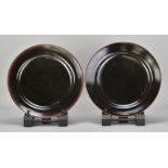 RUPERT SPIRA (born 1960); a pair of stoneware plates covered in tenmoku breaking to kaki glaze,