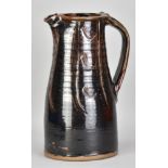 JIM MALONE (born 1946); a large stoneware pitcher covered in tenmoku breaking to kaki glaze with