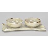 ALAN BIRCHALL (born 1945); a stoneware olive dish set comprising a pair of bowls and a tray