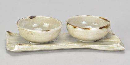 ALAN BIRCHALL (born 1945); a stoneware olive dish set comprising a pair of bowls and a tray