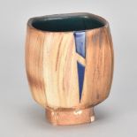 JEFF OESTREICH (born 1947); a faceted stoneware yunomi washed with iron with iron and cobalt