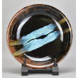 JAMES HAKE (born 1979); a shallow stoneware bowl covered in tenmoku breaking to kaki glaze with chun