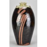 PHIL ROGERS (1951-2020); a large stoneware lugged bottle covered in tenmoku breaking to kaki glaze