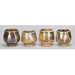 MICKI SCHLOESSINGK (born 1949); a group of four salt glazed yunomi with different glazes and