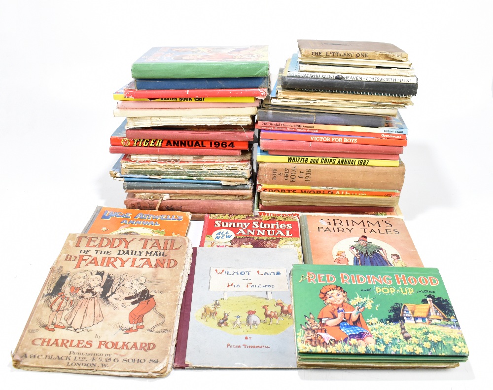 A collection of children's illustrated books, including The New Adventures of Rupert, A Perfect