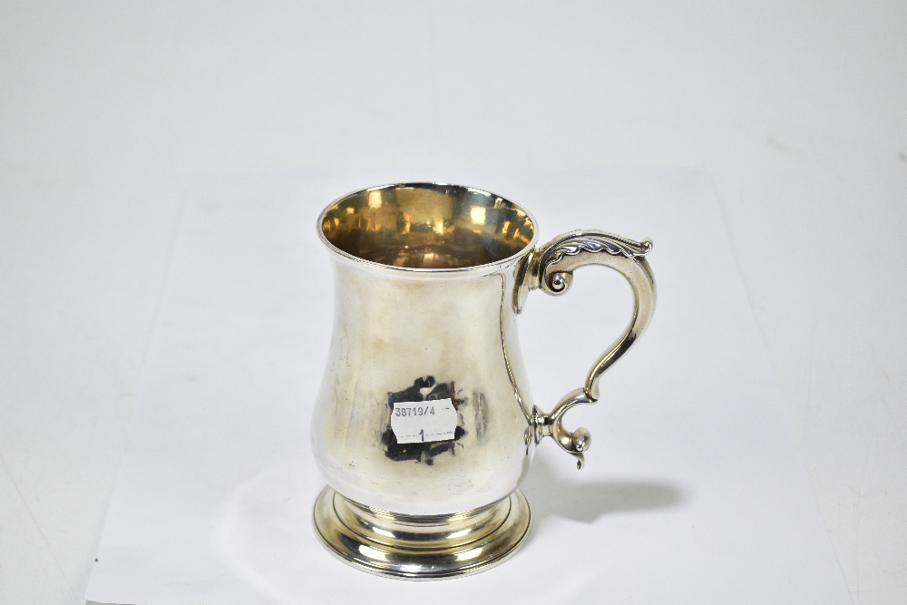 CGMB; a George III hallmarked silver baluster mug with cast scroll handle, London 1773, height 13cm, - Image 2 of 3