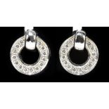 BOODLES; a pair of 18ct white gold and diamond set 'roulette' earrings, worn with either diamonds