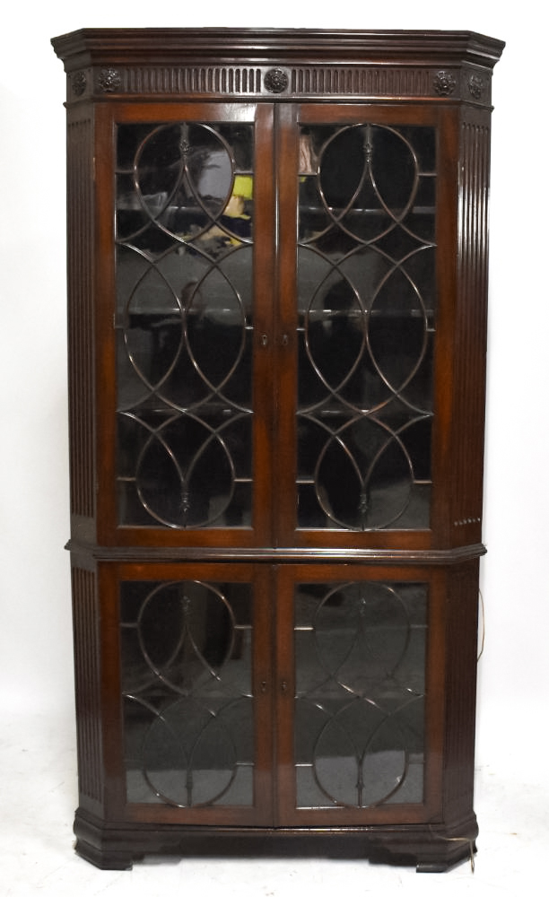 A George III mahogany freestanding corner cabinet, with moulded cornice above two pairs of