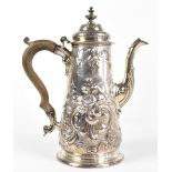 A mid 18th century hallmarked silver coffee pot with later repousse floral and scroll detailing,