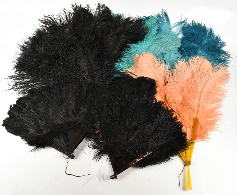 Eight 1920s large ostrich feather fans in a variety of colours, including turquoise, orange, blue,