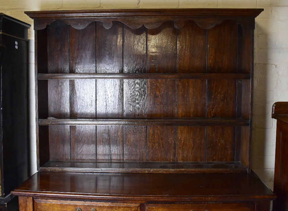 An Edwardian oak buffet, with associated plate rack top, above two drawers and two cupboard doors, - Image 3 of 3