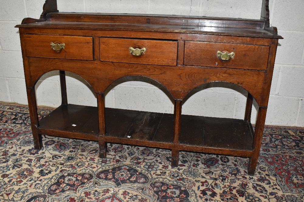 An 18th century oak dresser, with open plate rack back having central turned spindles and three - Image 3 of 3