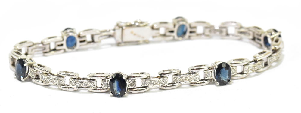 A diamond and blue stone set white metal bracelet, stamped 585, weight 18.1g.