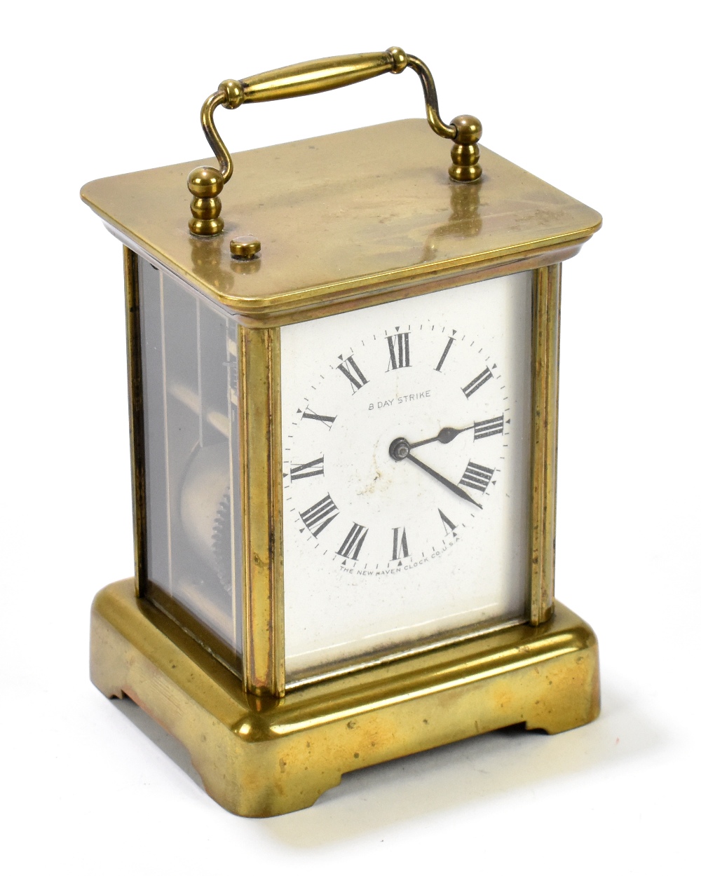THE NEW HAVEN CLOCK COMPANY USA; an eight day brass cased carriage clock, the enamel dial set with