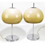 A pair of mid-century table lamps in the manner of Harvey Guzzini, with mushroom shaped shades, on