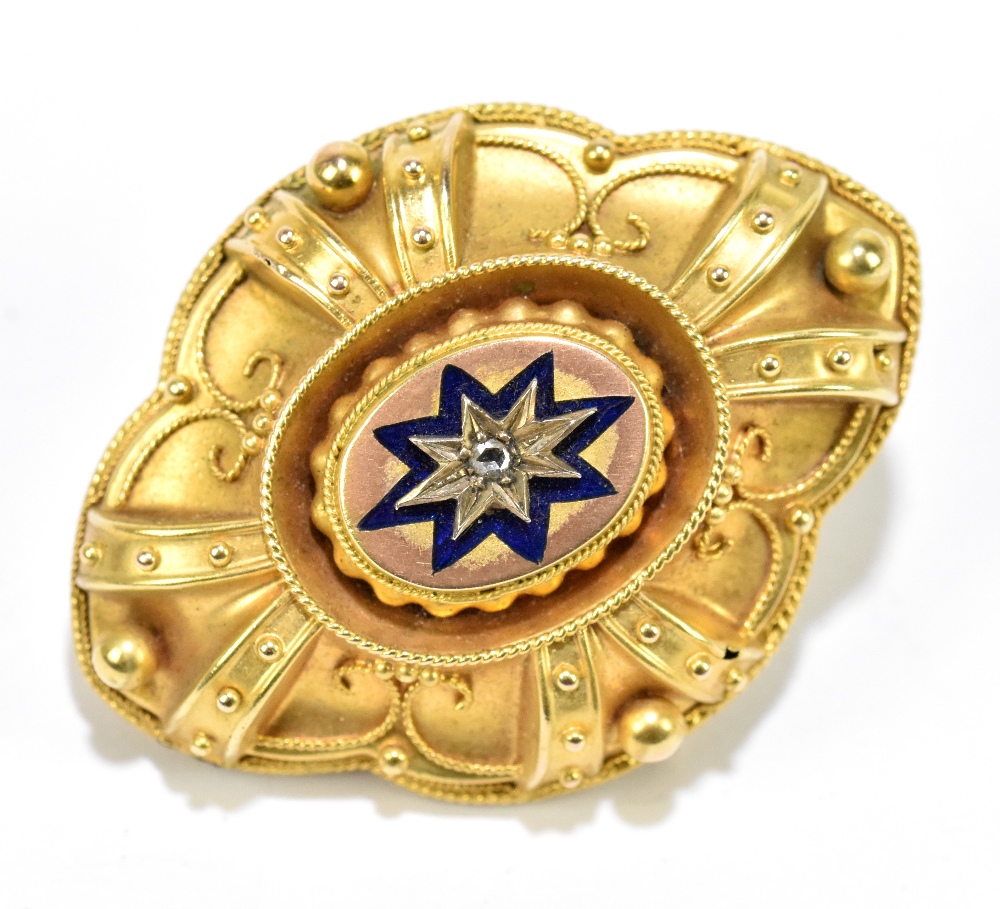 A Victorian yellow metal lozenge shaped brooch, with central enamelled star detail within a filigree