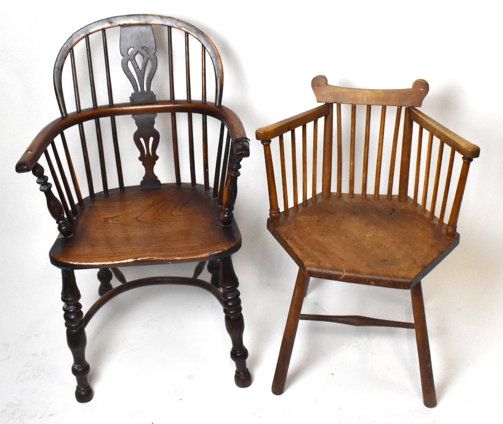 An 18th century elm and yew wood low Windsor armchair with crinoline stretcher, and a hexagonal