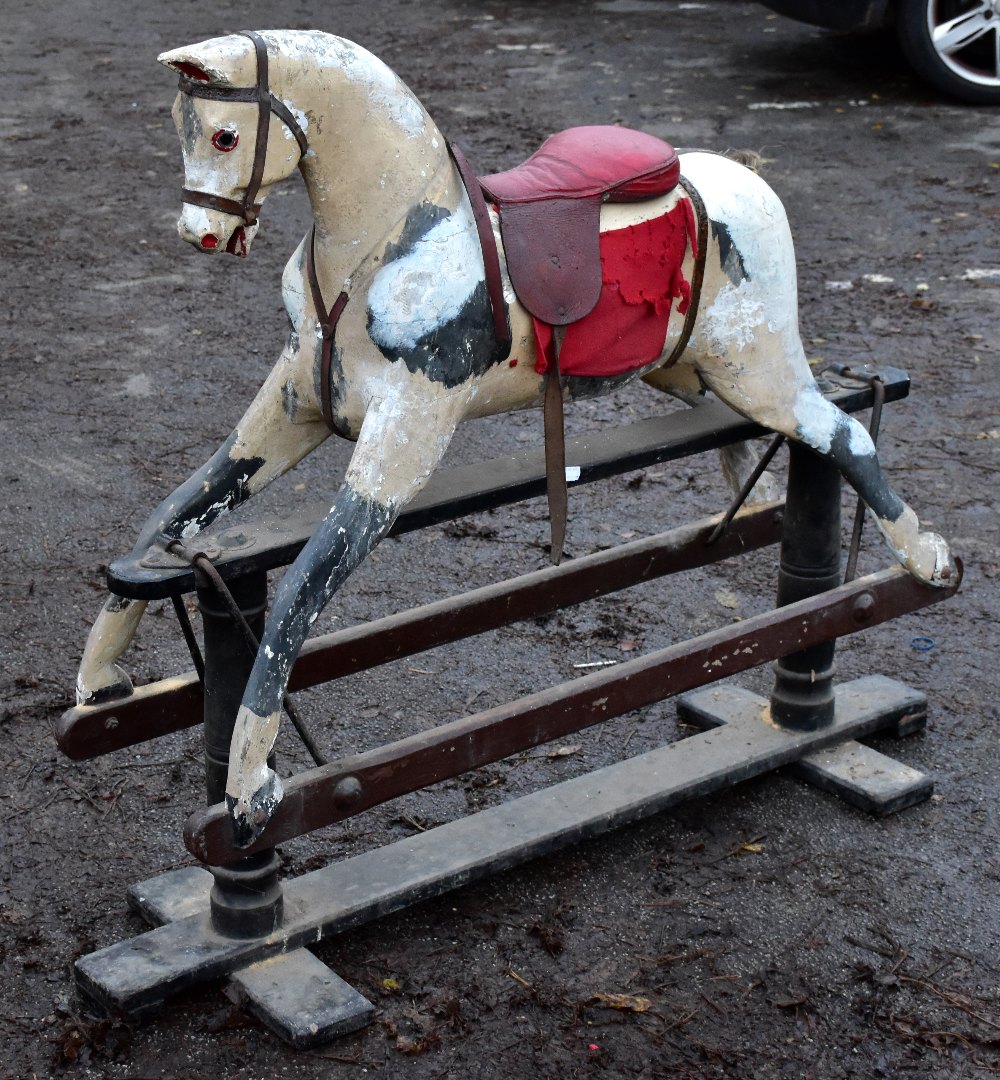 A painted rocking horse for restoration, length of stand approx 117cm.