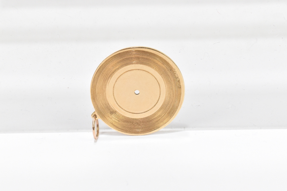 A novelty 9ct yellow gold pendant in the form of a record, inscribed to the centre 'HMV', and - Image 2 of 2