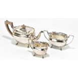 ADIE BROS; a George VI hallmarked silver three piece tea service of shaped oval form, on four