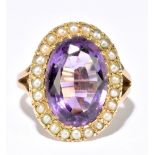 A 9ct yellow gold amethyst and seed pearl cluster ring, with pierced shoulders, size L, approx. 6.