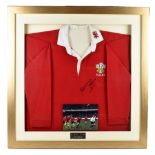 WALES RUGBY; a replica Wales red home shirt signed by the great rugby union player Barry John,