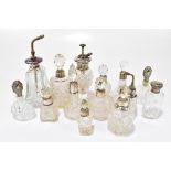 A collection of cut glass dressing table and perfume bottles with hallmarked silver collars/