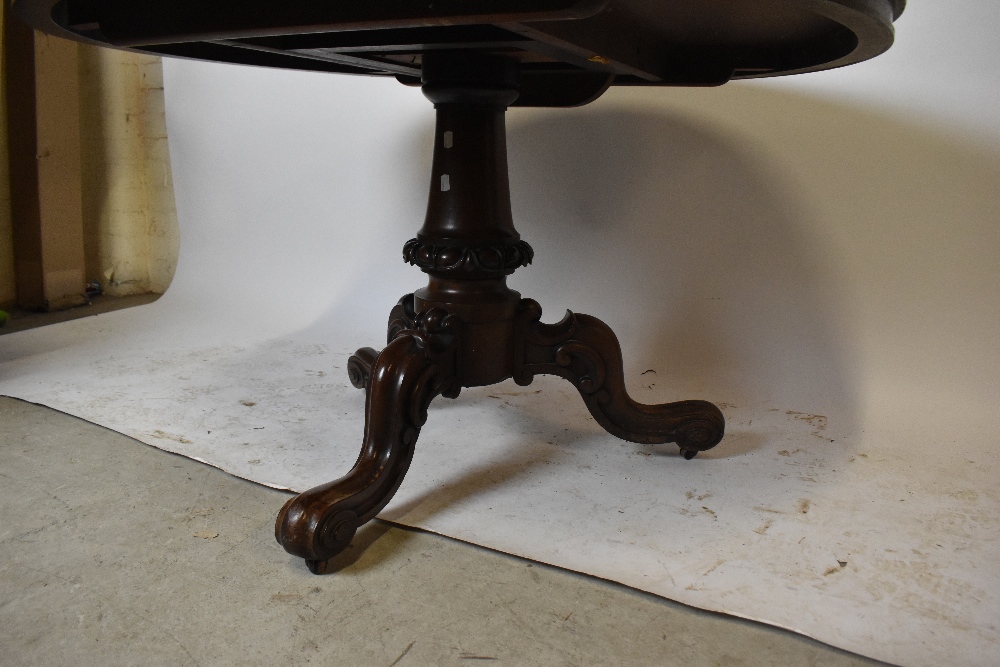 A 19th century rosewood breakfast table, the circular tilt-top on a turned column and tripod - Image 2 of 3