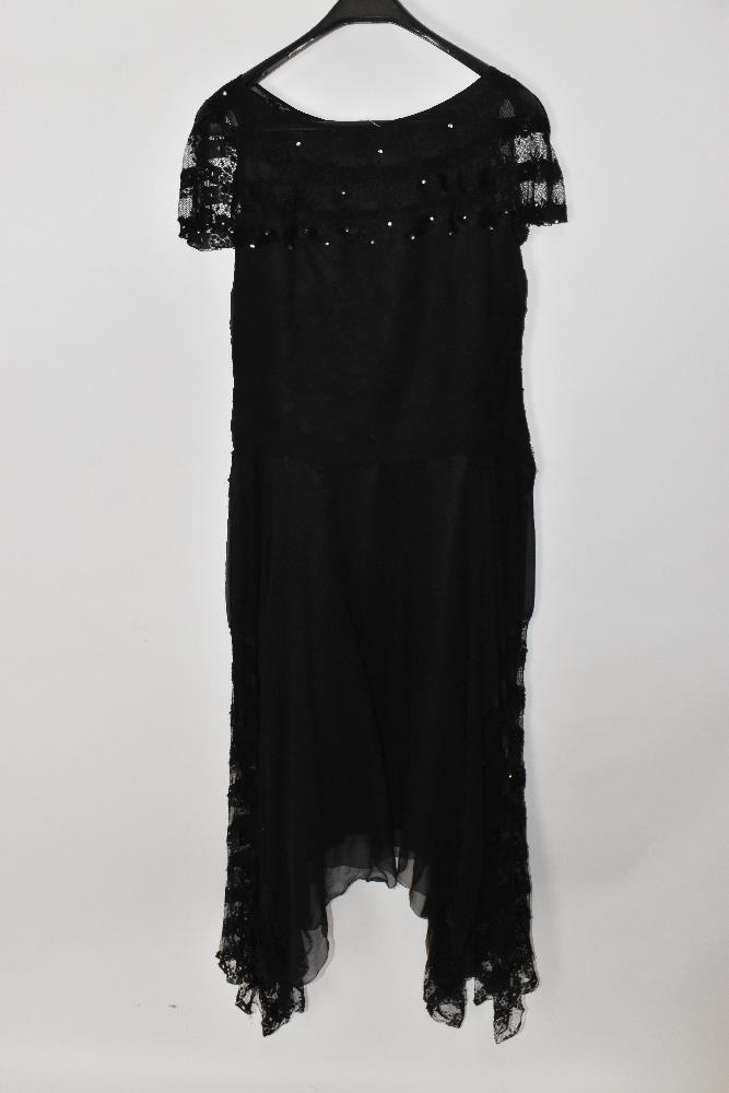 A 1920s black silk and handmade lace evening dress lined with silk with a swag hem embellished - Image 4 of 4