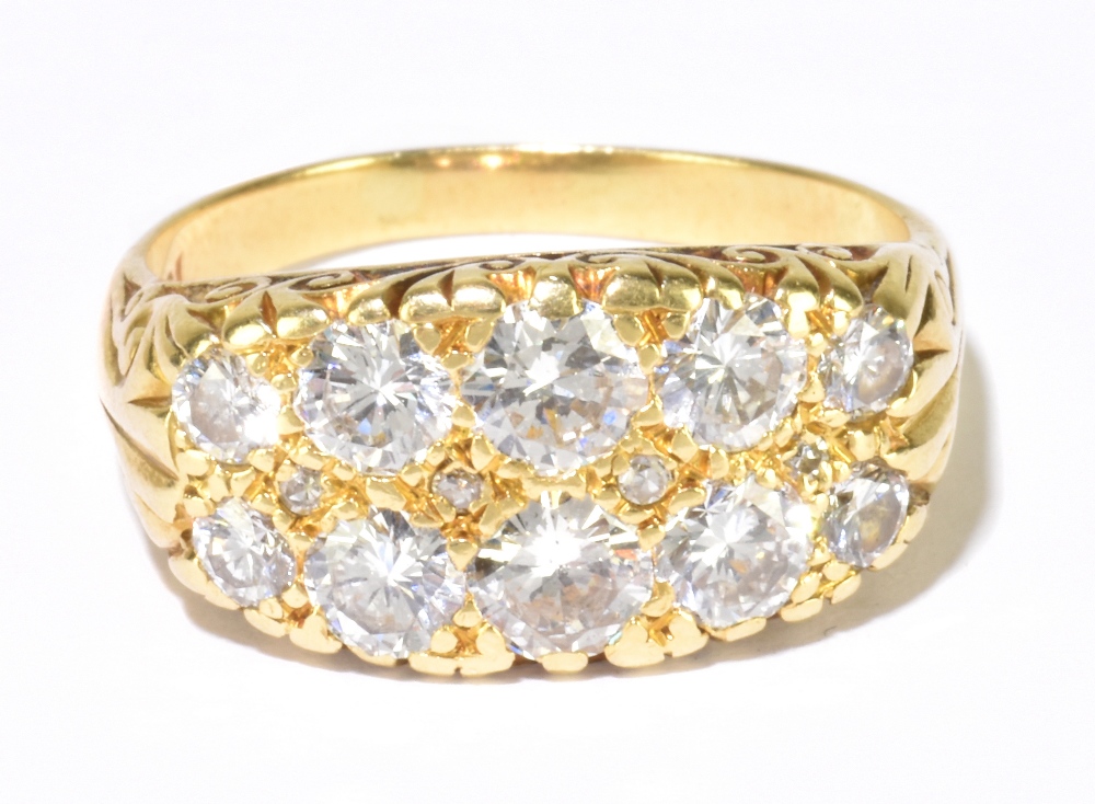 An 18ct yellow gold and diamond fourteen stone twin row graduated diamond ring, the two largest