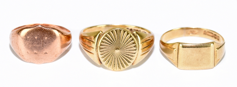 Two 9ct yellow gold rings and a 9ct rose gold ring, rose gold size O, yellow gold size T and Y,