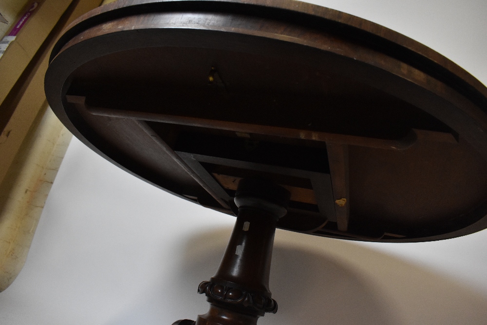 A 19th century rosewood breakfast table, the circular tilt-top on a turned column and tripod - Image 3 of 3
