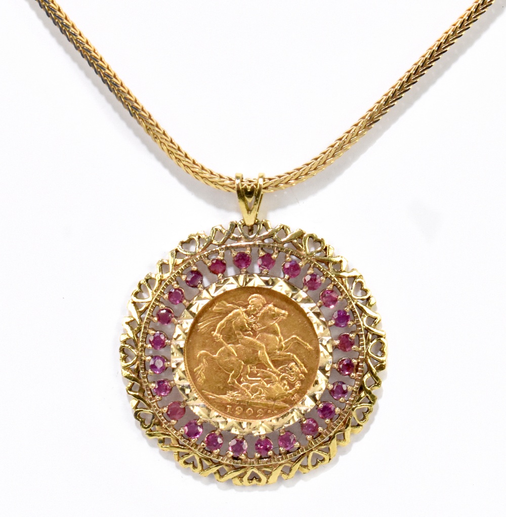 An Edward VII full sovereign, 1902, Perth Mint, in elaborate pierced frame and suspended on 9ct