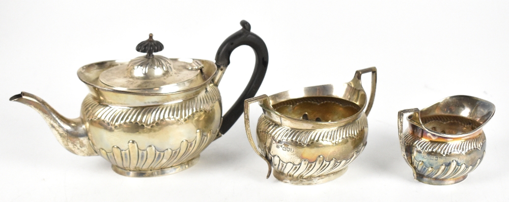 DANIEL & JOHN WELBY; a late Victorian hallmarked silver three piece part gadrooned tea set, length