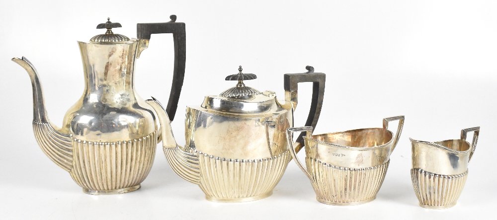 WALKER & HALL; a late Victorian silver three piece tea service with ebonised finial and handle,