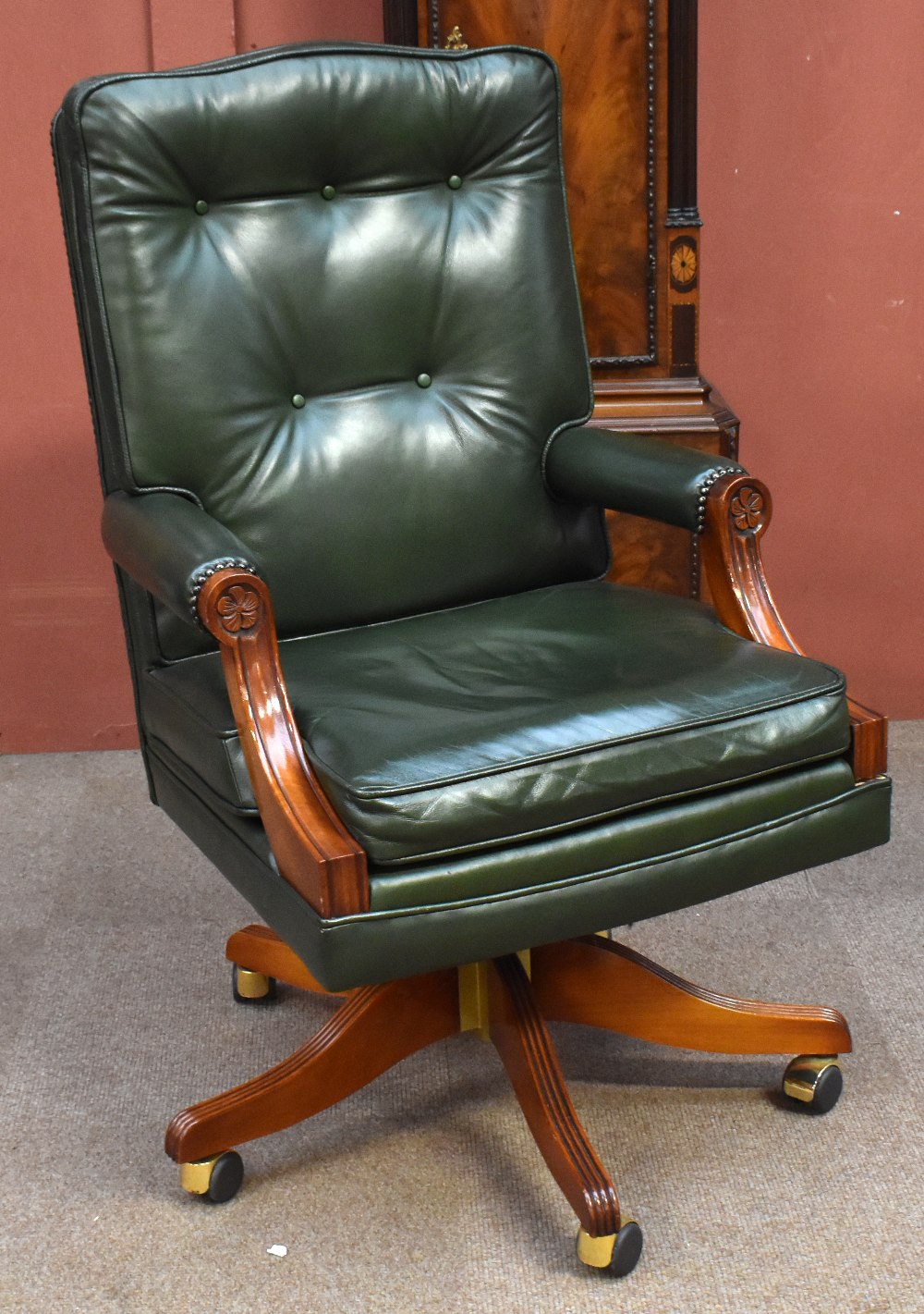 A reproduction mahogany and green leather swivel office chair.Additional InformationSwivel is