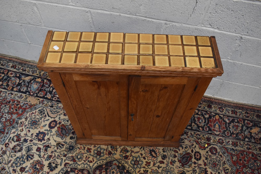 A pine two door cupboard, with tiled top enclosing one fixed shelf, height 89cm, width 69.5cm, depth - Image 2 of 3