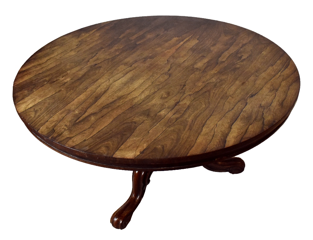 A 19th century rosewood breakfast table, the circular tilt-top on a turned column and tripod